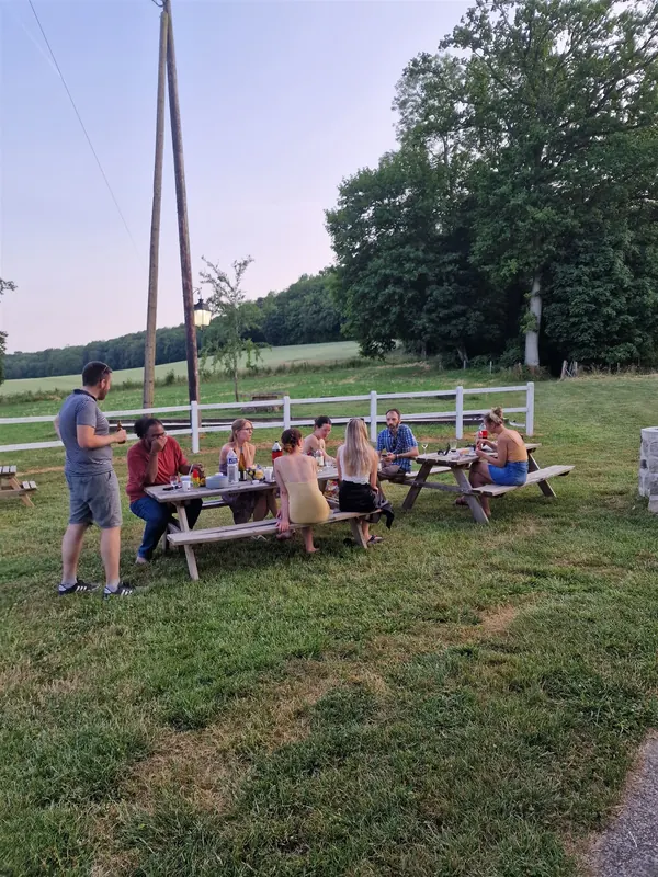Dîner en plein air : les participants autour des tables dans le parc